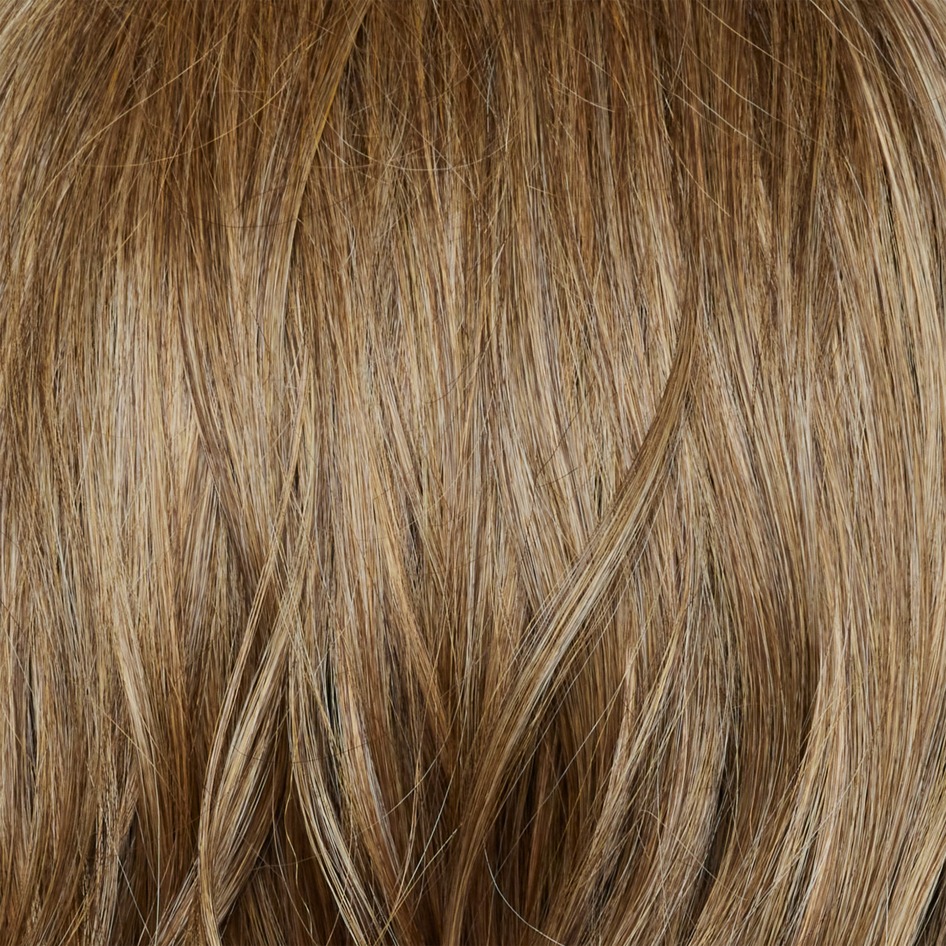 Caramel Biscotti  -  A beautiful mid/dark blond hair color with delicate caramel blond highlights seamlessly blended throughout, creating a warm and inviting look.