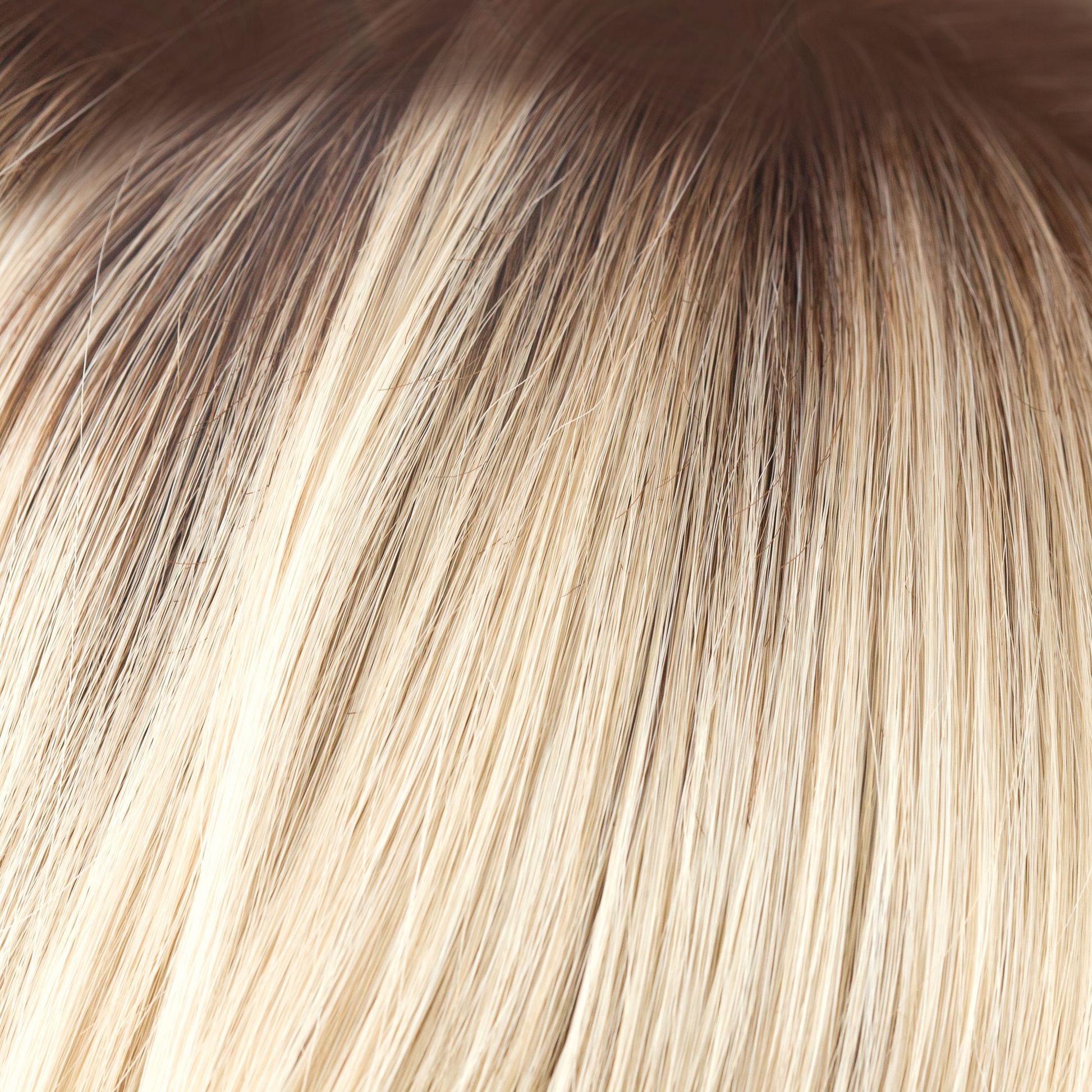 Champagne-R  -  A luxurious color with many fine tones of blond. Cream blonds, champagne hues and pale gold undertones make the blond a work of art! The medium warm brown root gives it the most natural of regrowths and keeps it looking very realistic.