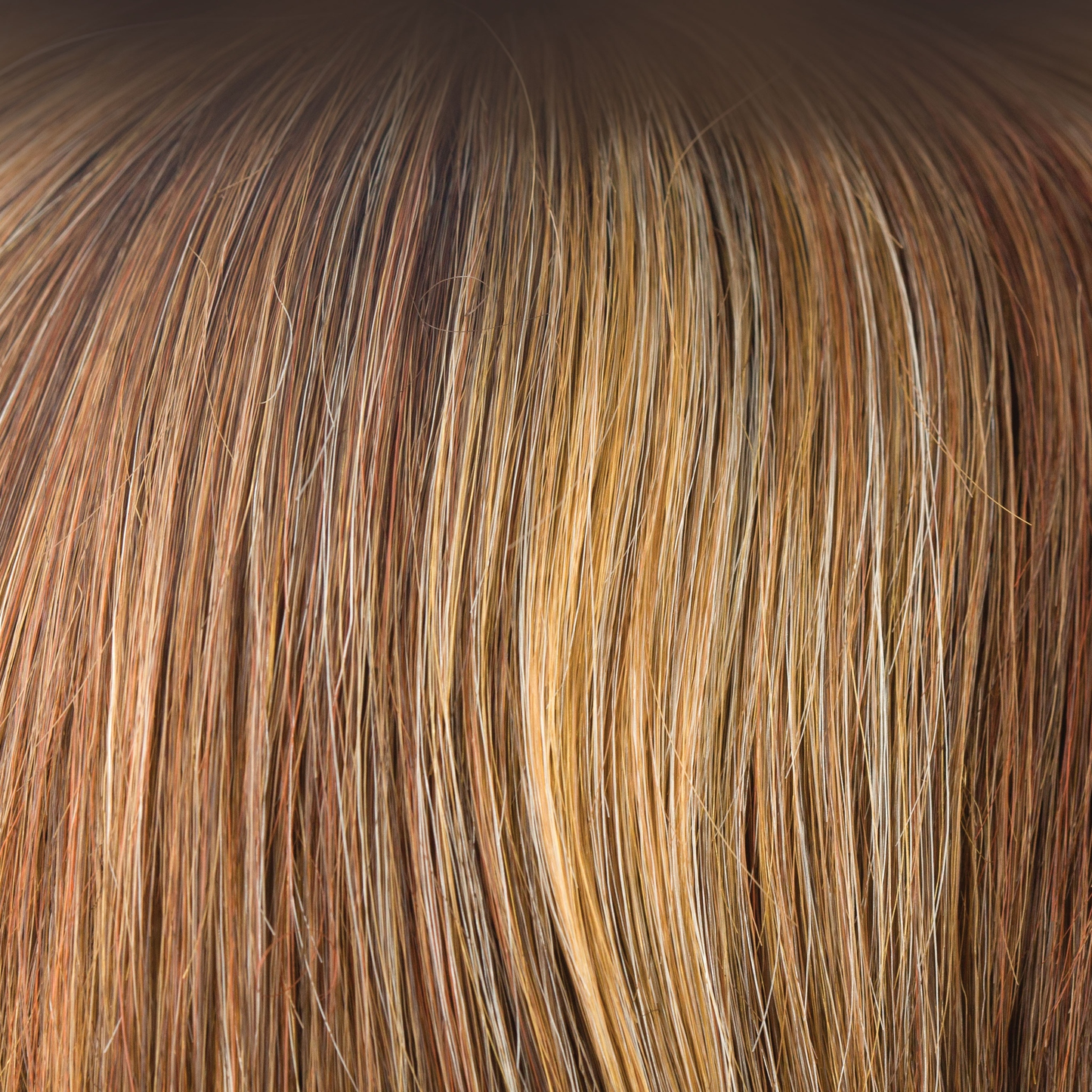 Copper Glaze-R  -  This rooted version of Copper Glaze has a regrowth of dark to medium amber brown and has honey gold blond highlights, scattering through to a medium copper brown. A much loved autumnal shade, this is both flattering and warm.