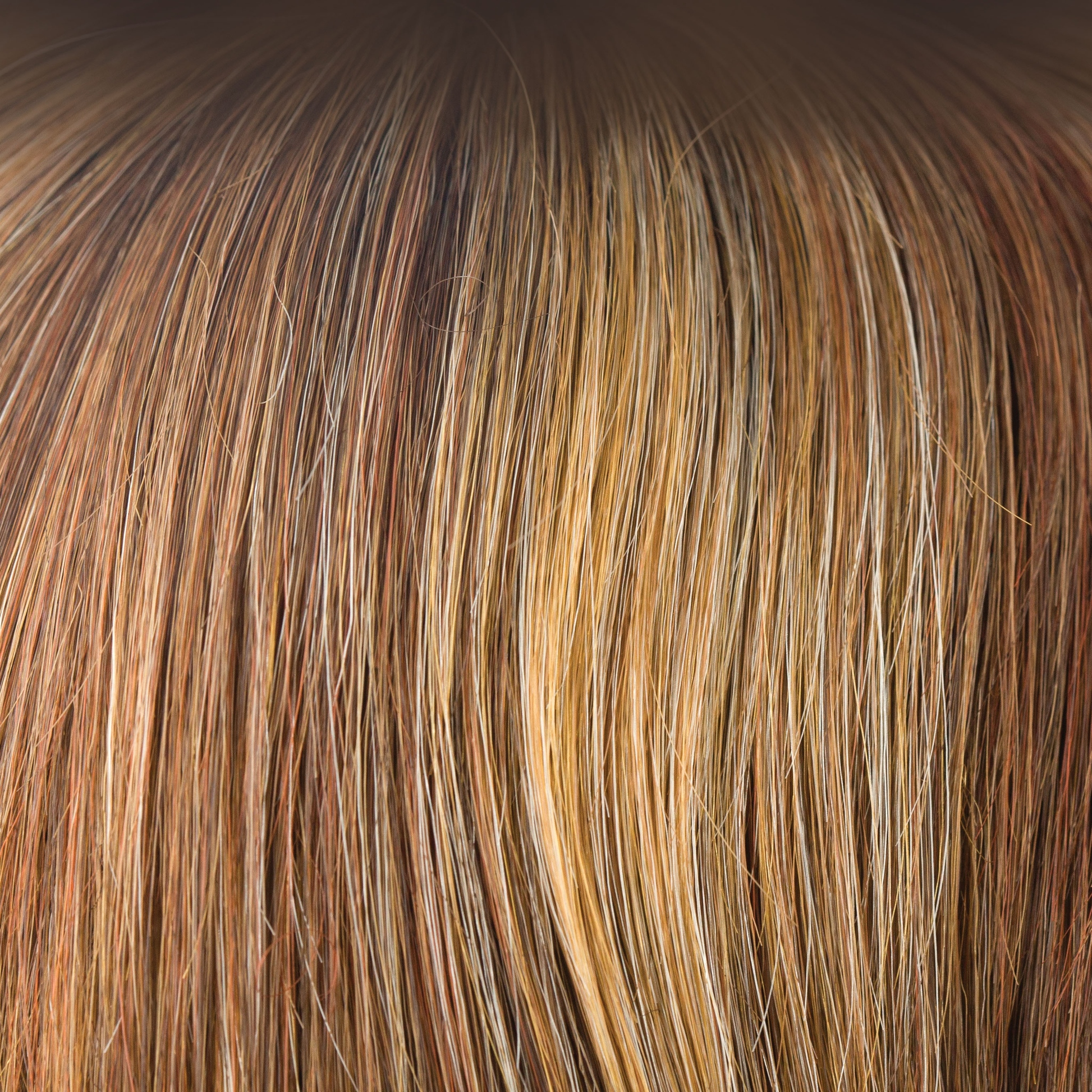 Copper Glaze  -  Has honey gold blond highlights scattering through a medium copper brown base. A much loved autumnal shade. This is flattering and warm. It is a great choice if you like a highlighted red copper.