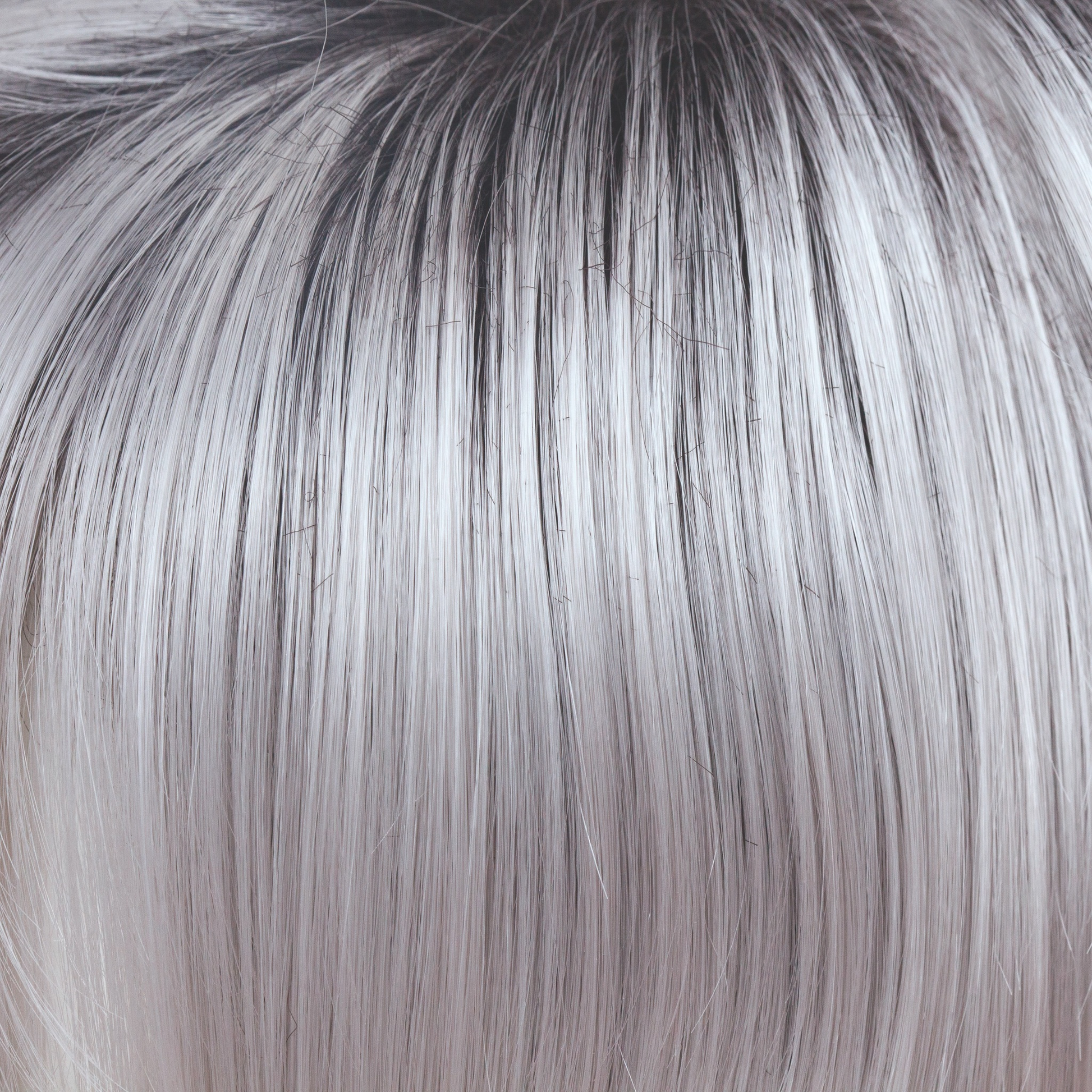 Illumina-R  -  A truly stunning color! This striking iridescent white gives off hues of silver and pales purples. The dark brown root has an appearance of natural regrowth. Illumina-R is fashion forward and toned to perfection.